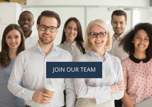 Eight diverse professionals smiling in an office, with a blue banner in the foreground that reads 'JOIN OUR TEAM'